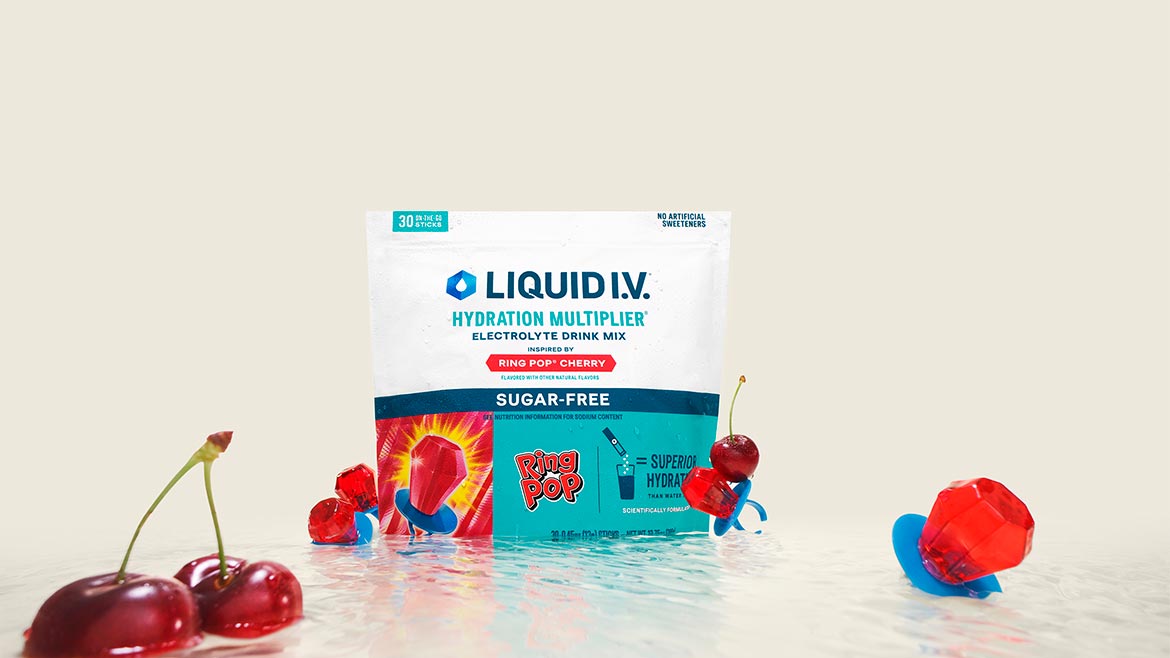 Package of sugar-free hydration drink mix in Ring Pop cherry flavor displayed with cherries and candy, highlighting electrolyte hydration and functional beverage nutrition.