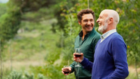 Two men drinking wine outdoors