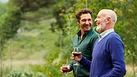 Men more involved with wine Two men drinking wine outdoors