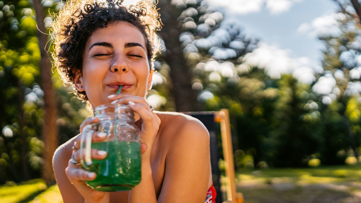 Woman drinking green juice