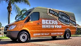 van wrapped in beer advertising