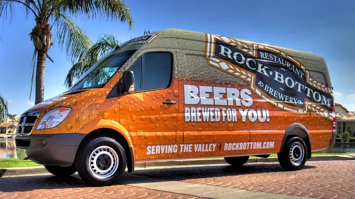 van wrapped in beer advertising