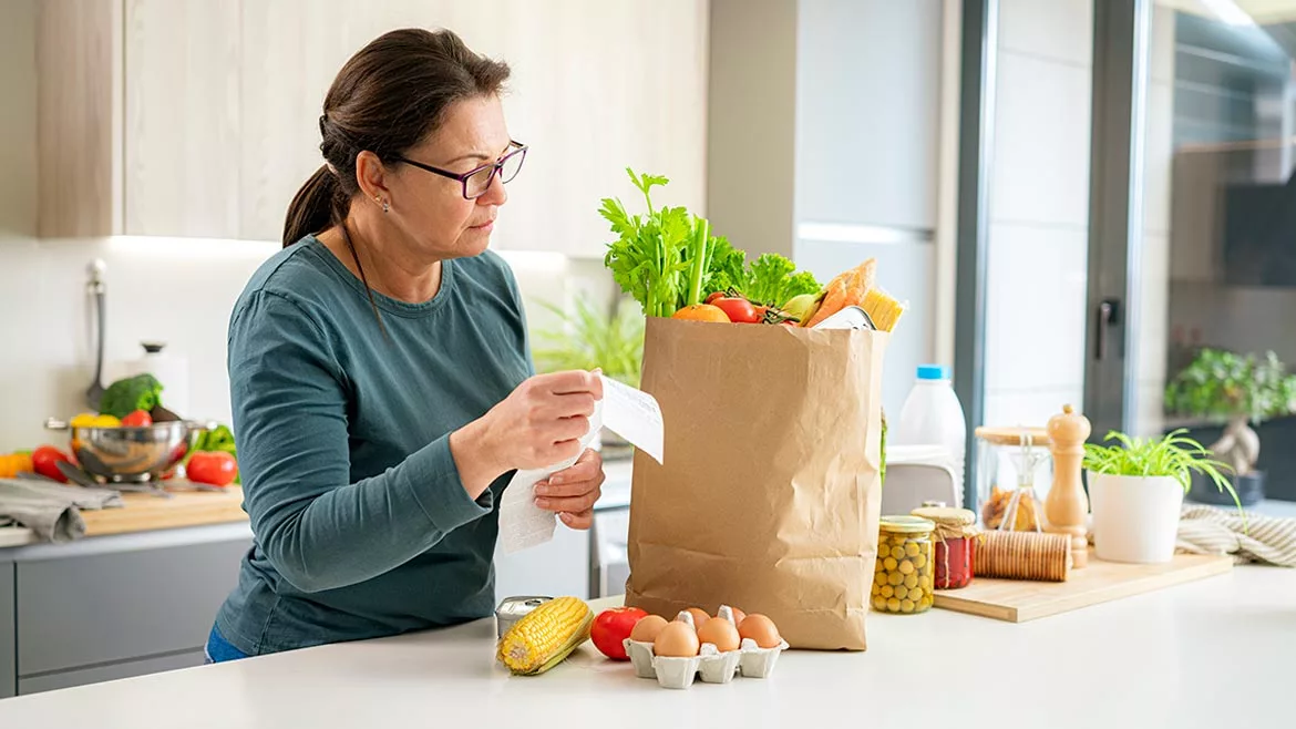 woman looking at her grocery purchases