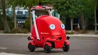 The image shows Dot, an autonomous delivery robot developed by DoorDash. The image shows Dot, an autonomous delivery robot developed by DoorDash.