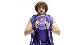  person dressed in 1980s-inspired workout attire, promoting the new BuzzBallz "Grapes Gone Wild" flavor and a limited-edition "KettleBallz" kit. 