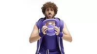  person dressed in 1980s-inspired workout attire, promoting the new BuzzBallz "Grapes Gone Wild" flavor and a limited-edition "KettleBallz" kit. 
