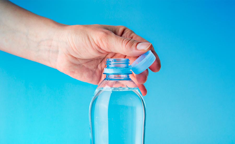  a person using a plastic beverage bottle 