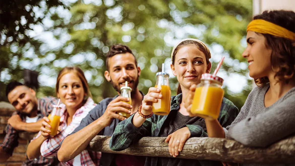 a group of happy friends enjoying drinks outdoors a group of happy friends enjoying drinks outdoors