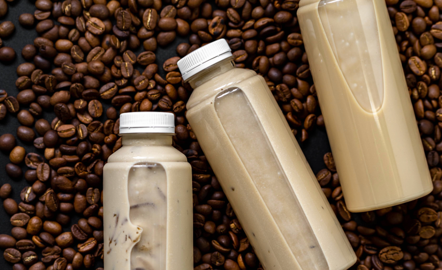 The image displays bottles of ready-to-drink iced coffee or latte beverages. 