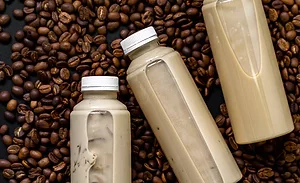 The image displays bottles of ready-to-drink iced coffee or latte beverages. The image displays bottles of ready-to-drink iced coffee or latte beverages.