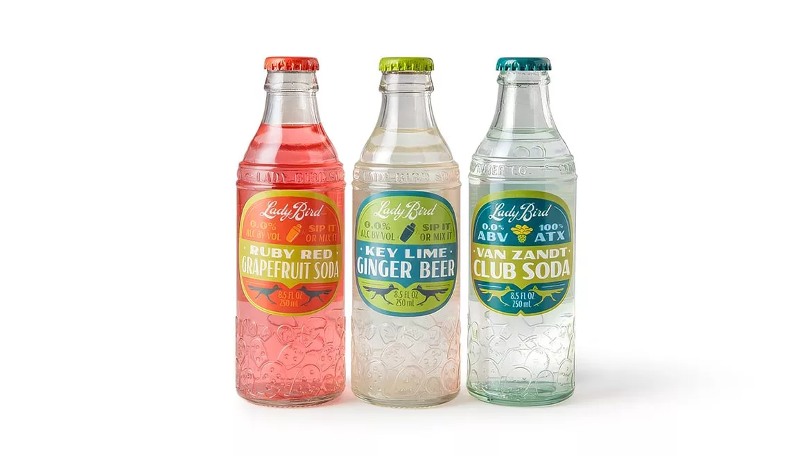 These are Lady Bird Soda brand cocktail mixers and sodas featuring Texas-inspired flavors. 