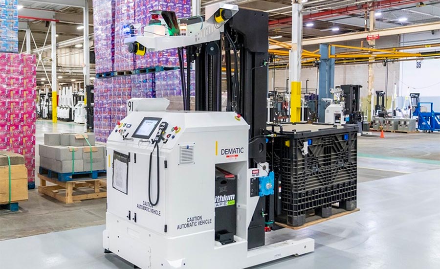 a Dematic automated guided vehicle (AGV) transporting a black pallet container