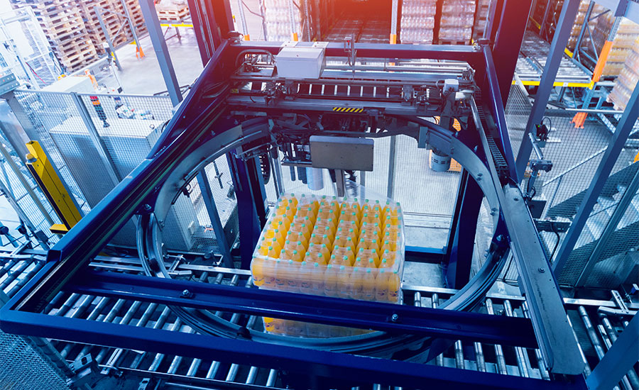 An automated industrial strapping machine used for securing goods on a packaging line.