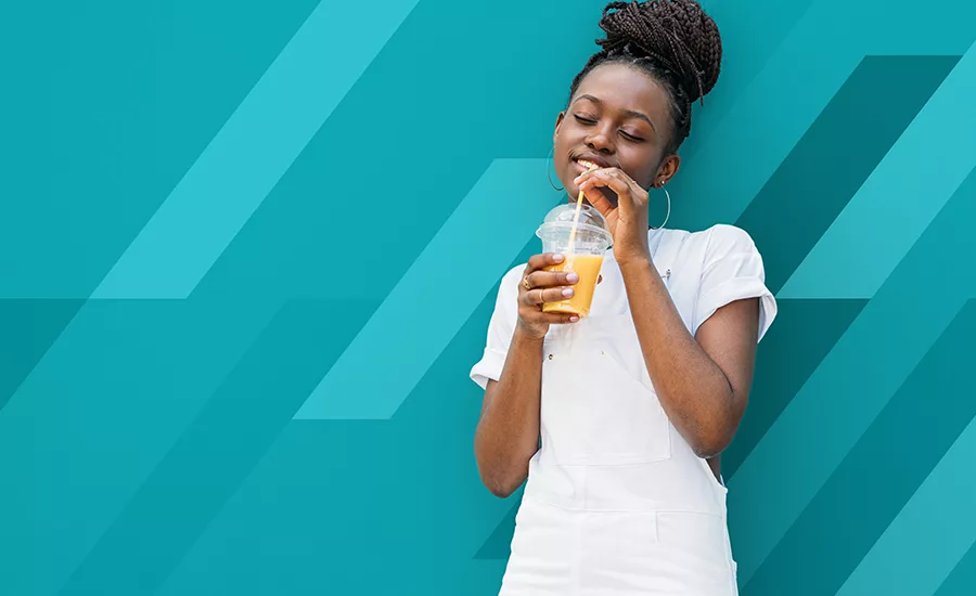 Young Woman In White Clothes Drinking Orange Juice