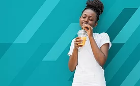 Young Woman In White Clothes Drinking Orange Juice