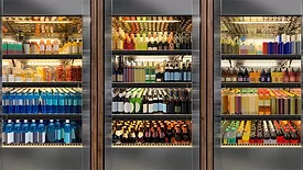 These commercial glass door refrigerators are stocked with a variety of beverages, including sodas and wines.
