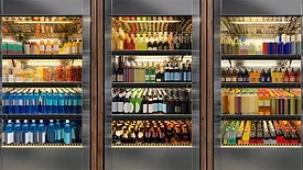These commercial glass door refrigerators are stocked with a variety of beverages, including sodas and wines.