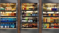 These commercial glass door refrigerators are stocked with a variety of beverages, including sodas and wines.