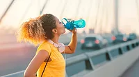  a person staying hydrated while exercising