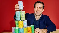 Jake Bullock, the co-founder and chief executive officer of the THC-infused social tonic brand Cann, posing alongside a stacked pyramid of various Cann beverage cans Jake Bullock, the co-founder and chief executive officer of the THC-infused social tonic brand Cann, posing alongside a stacked pyramid of various Cann beverage cans