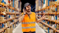 a person wearing a safety vest and a headset in what appears to be a warehouse setting a person wearing a safety vest and a headset in what appears to be a warehouse setting