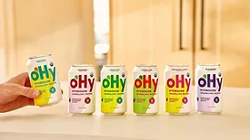 an assortment of oHy Hydrogen Sparkling Water cans in organic flavors like Blackberry, Lemon Lime, Cherry Lime, Strawberry Lemon, and Raspberry