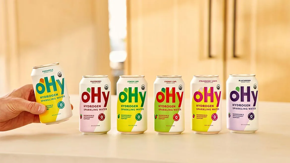 an assortment of oHy Hydrogen Sparkling Water cans in organic flavors like Blackberry, Lemon Lime, Cherry Lime, Strawberry Lemon, and Raspberry