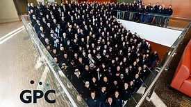  a large group of people and the logo for GPC, which stands for Gillette Pepsi-Cola Companies