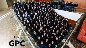  a large group of people and the logo for GPC, which stands for Gillette Pepsi-Cola Companies